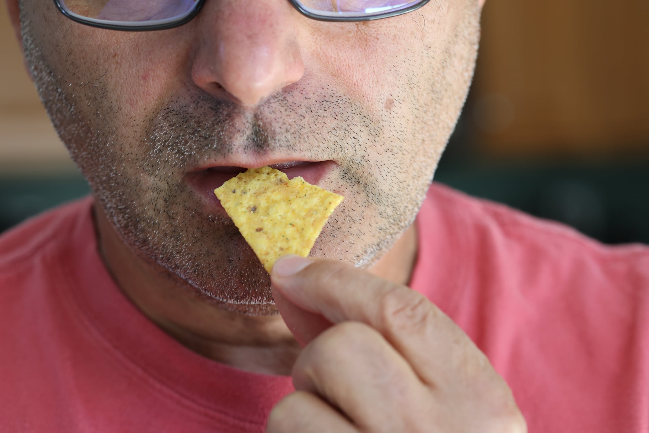 Close-up of man eating chips