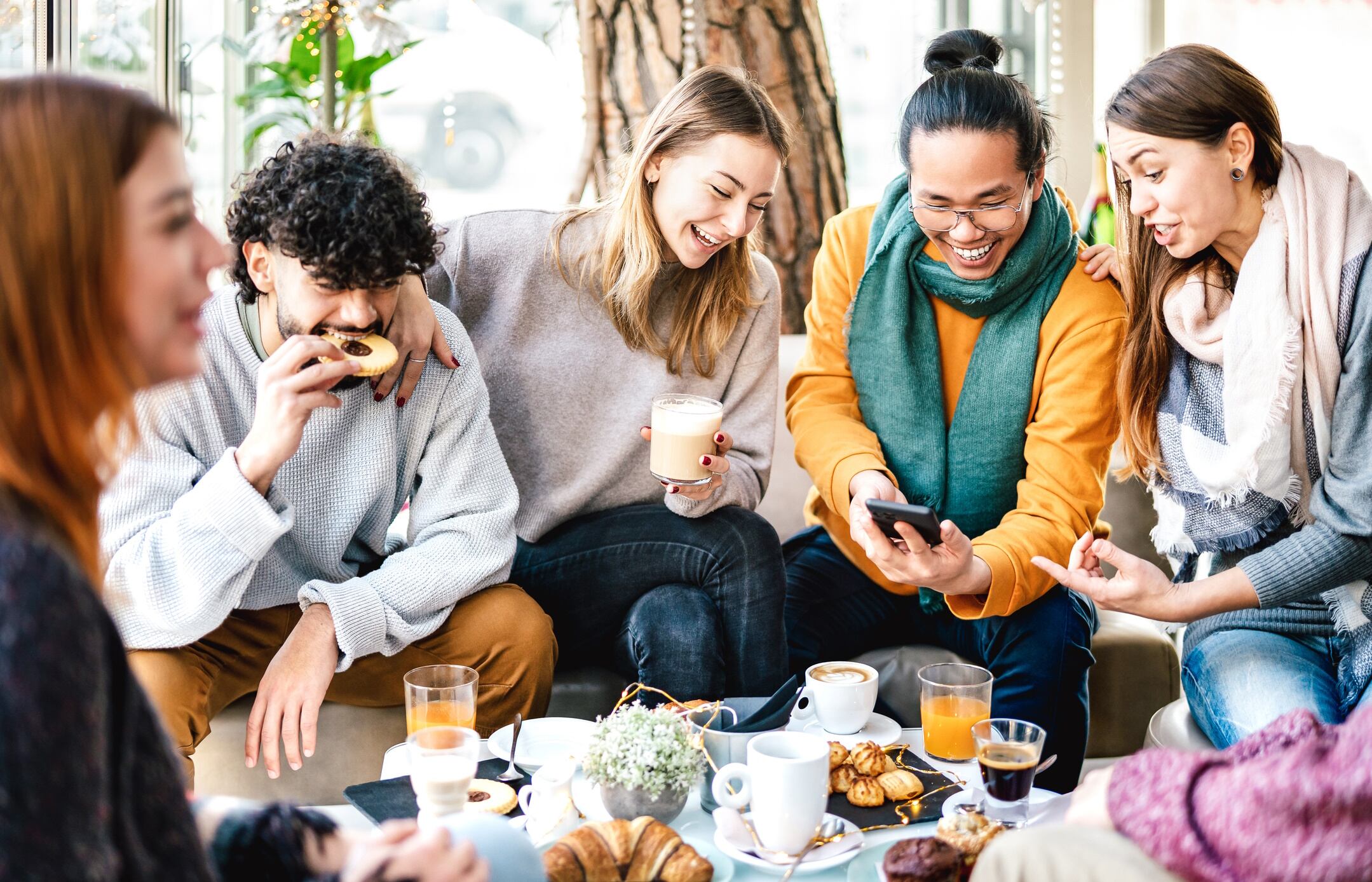 Group of Gen Z and Millennials enjoying snacks together