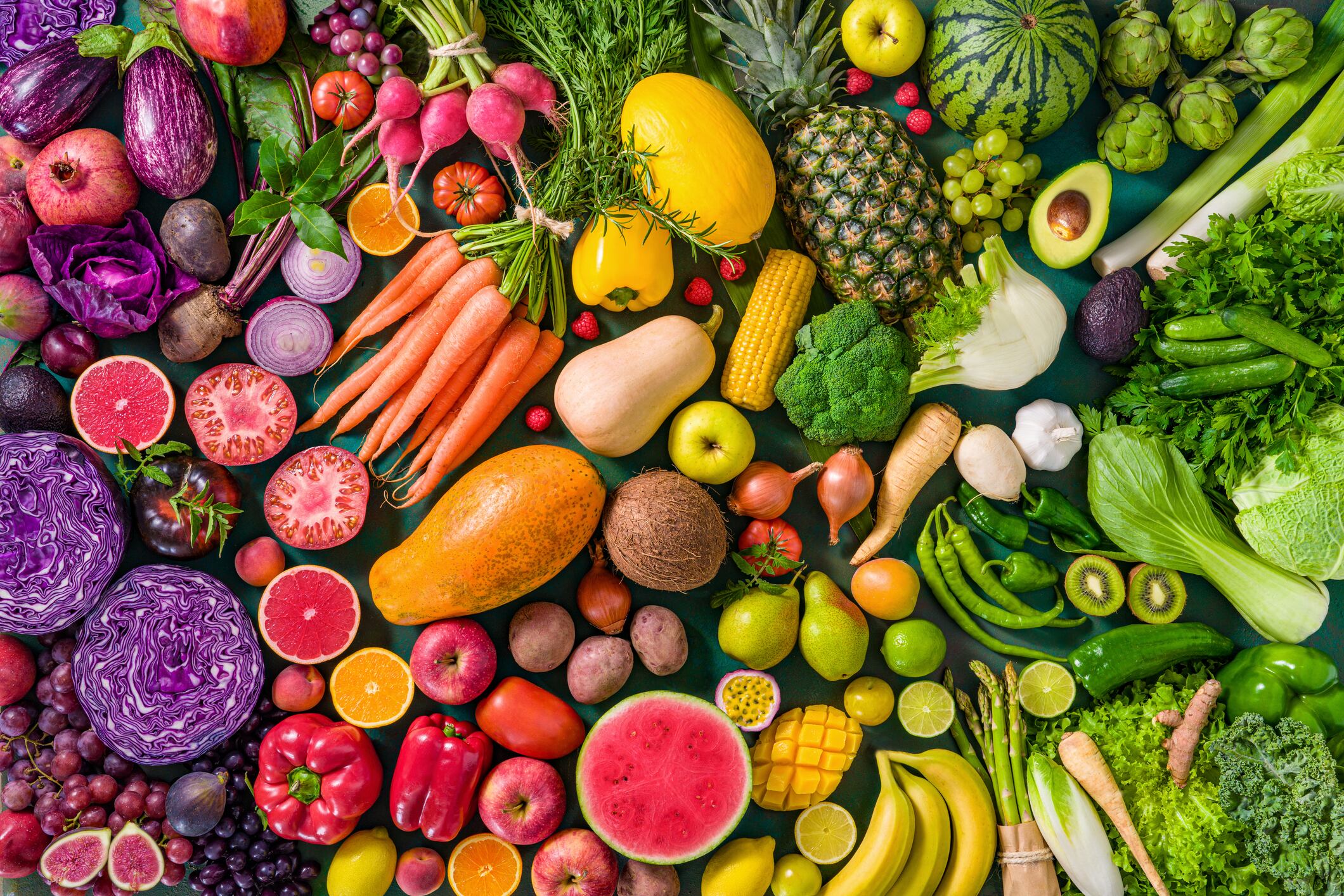Colorful raw fruits and vegetables varied, vivid rainbow arrangement