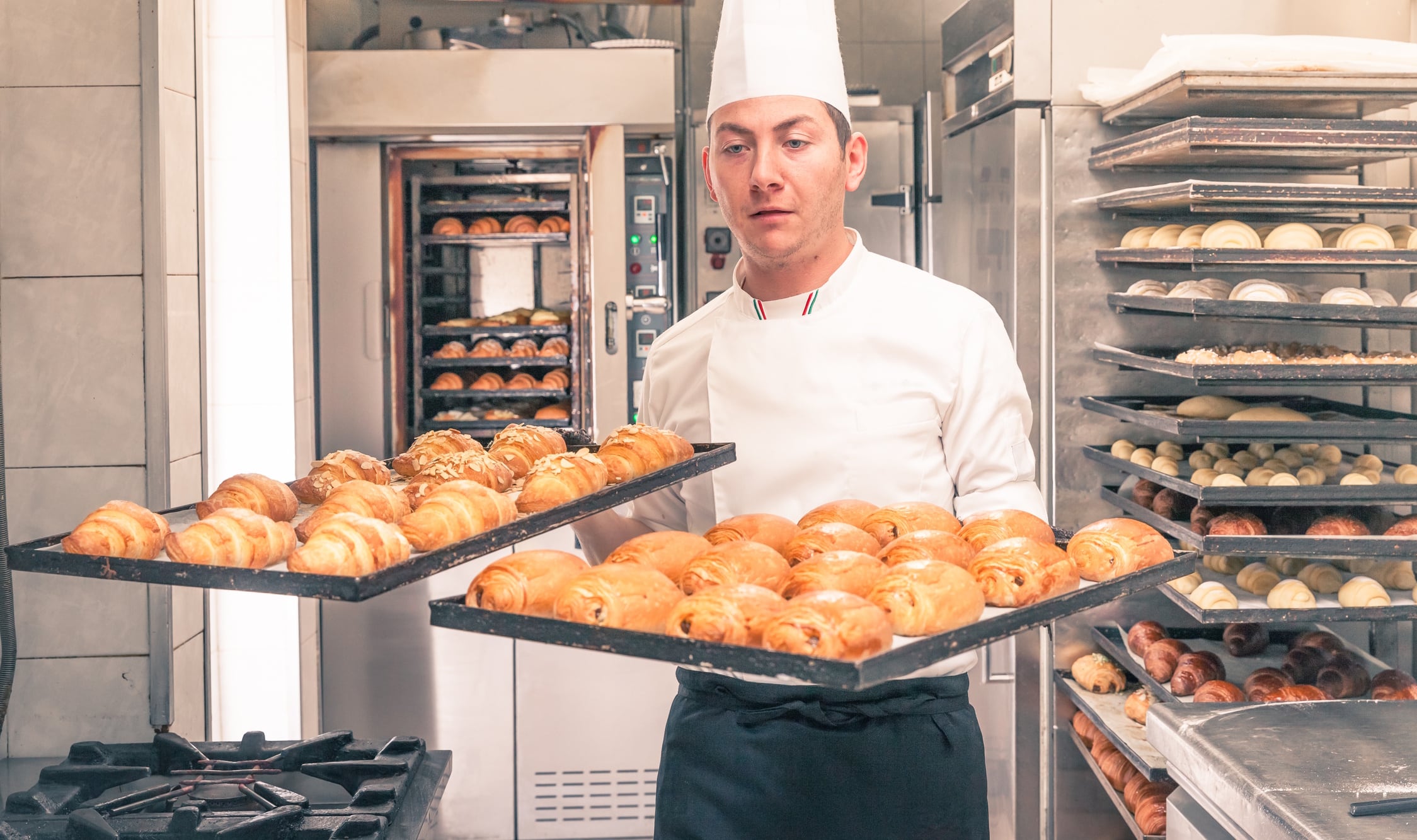 Baker with croissants Tommaso Tagliaferri GettyImages