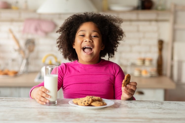 Young-girl-smiling-with-a-biscuit-Cargill.jpg