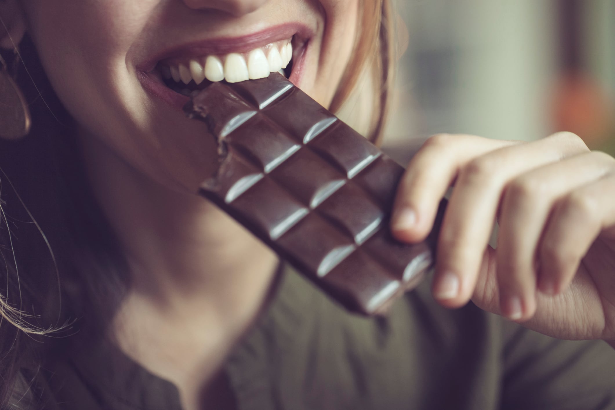 Woman eating a bar of chocolate