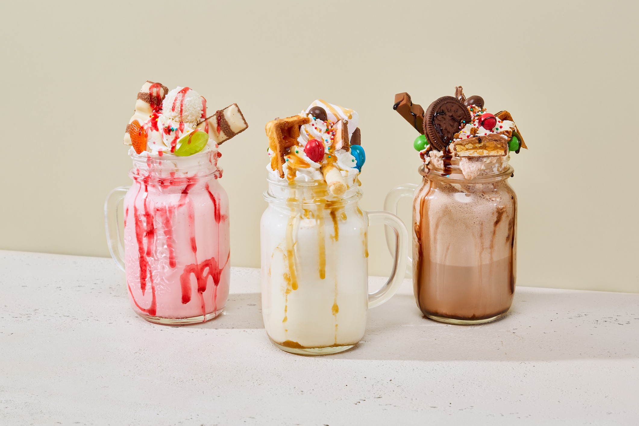 Three freakshakes - one strawberry, one banana, and one chocolate.