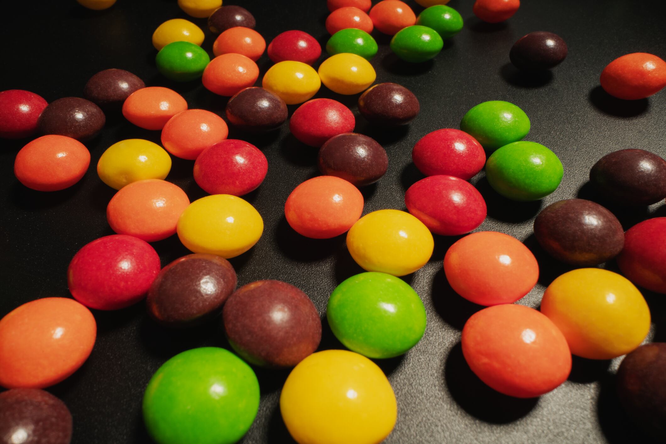Multicoloured confectionery on black background