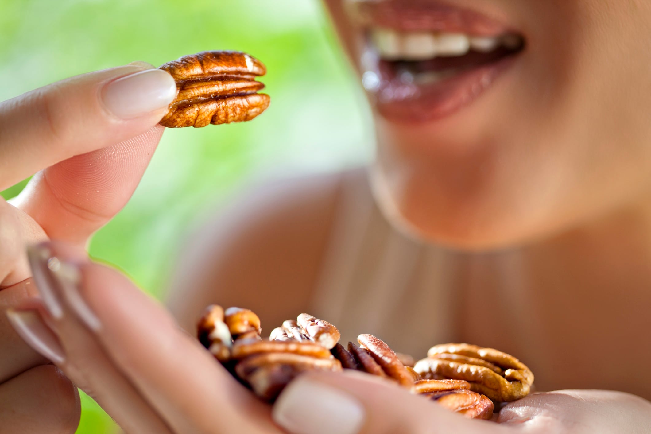 Woman with handful of pecans