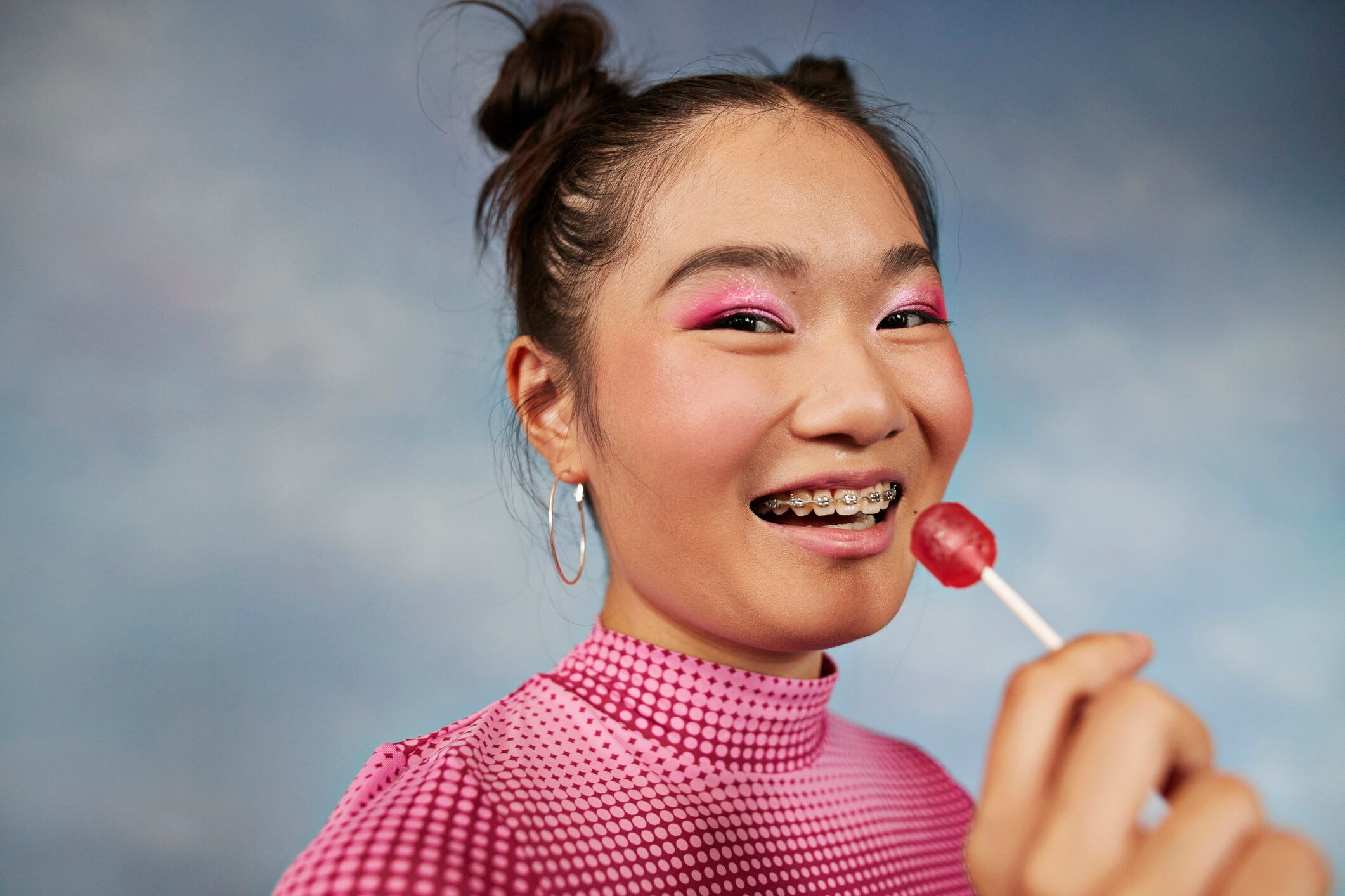 Young woman holding lollipop