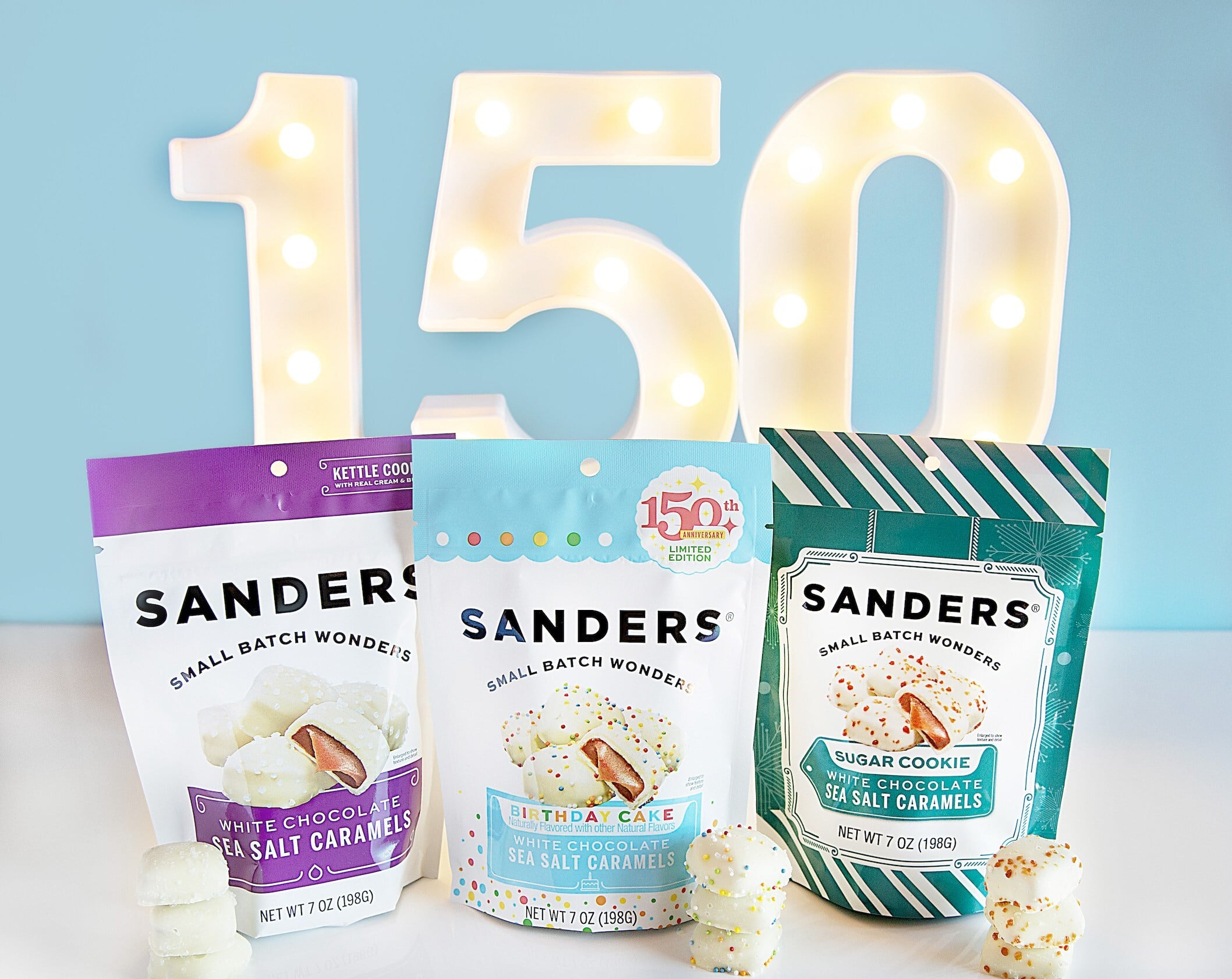 Still life of three of the new white chocolate sea salt caramel collection SKUs from Sanders.