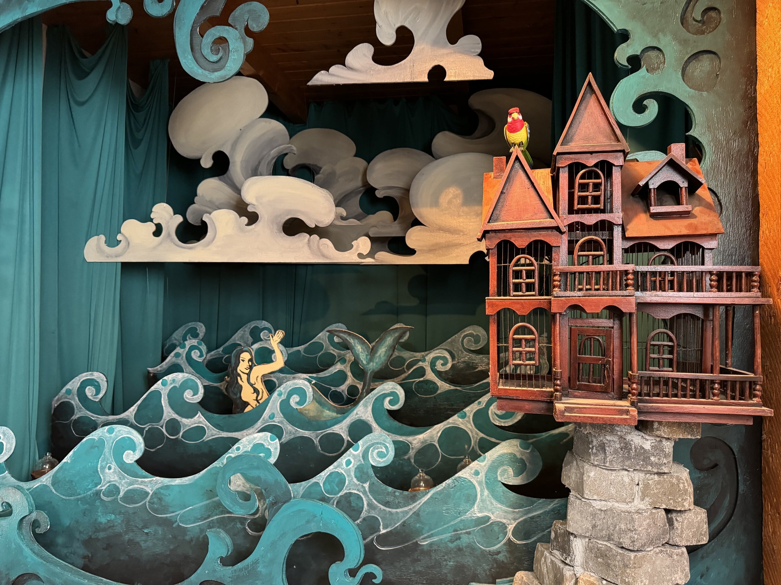 Paper waves, clouds and a Victorian house in a 3d design, form part of the Mermaid Chocolate Dispensing device at The Dotty Wampus Chocolate Factory in Cortez, Colorado.