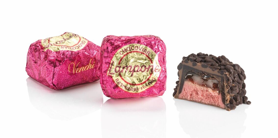Close-up of Venchi Chocoviar chocolates with textured chocolate grain coating, showcasing new Raspberry and Gianduia variants.