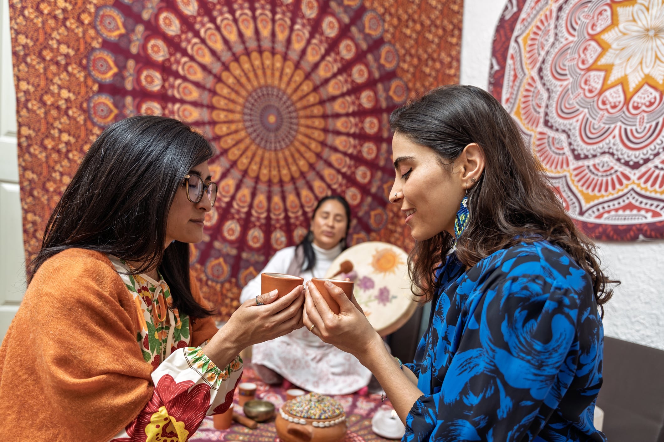 Women holding cups during organic cacao ceremony Guillermo Spelucin Runciman GettyImages