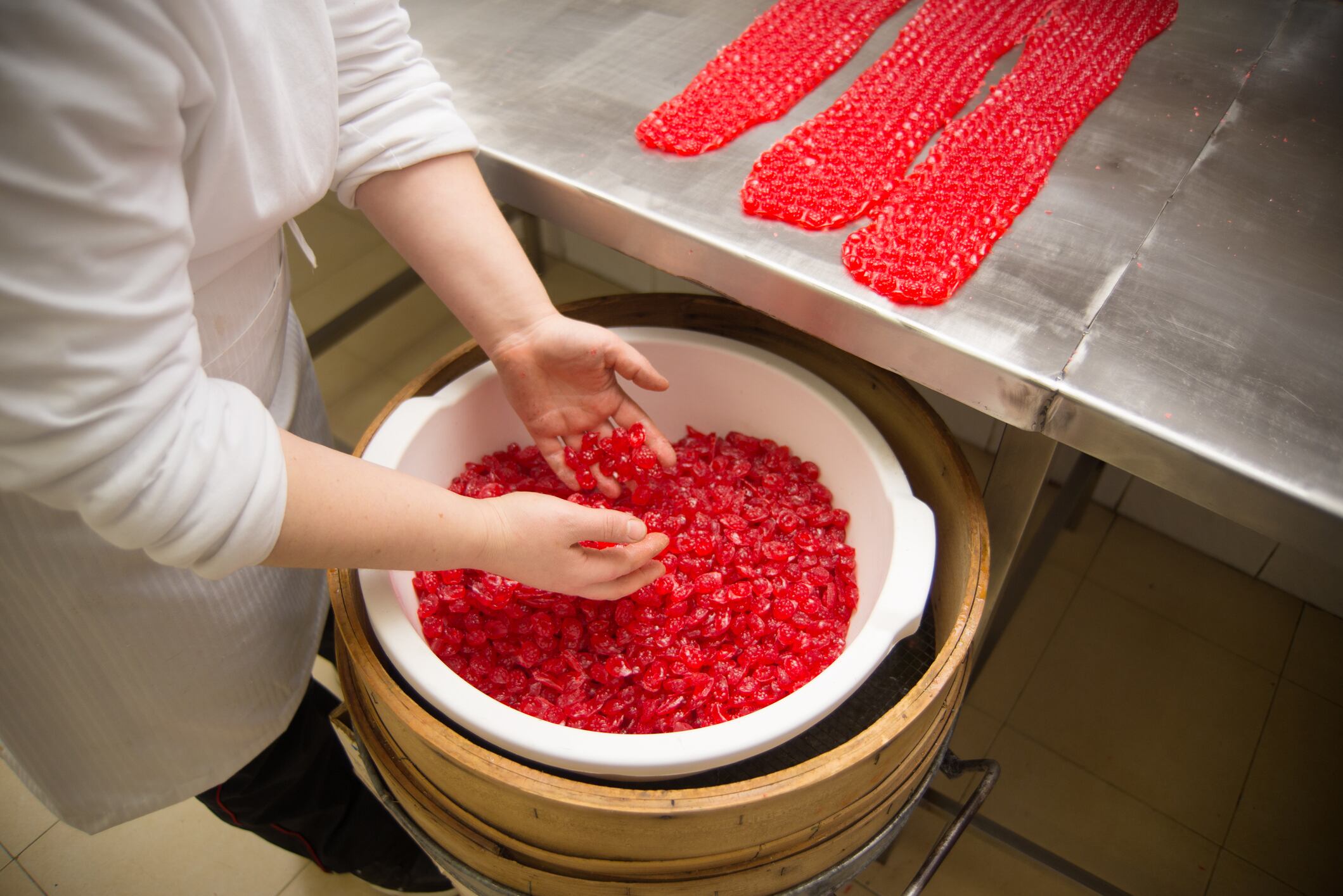 Woman in candy workshop preparing candy for sale.