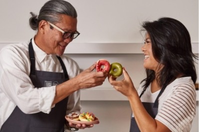 Chef Morimoto and Glbal Grub founder Carley Sheehy toast their collaboration with mochi doughnuts. Pic: Global Grub