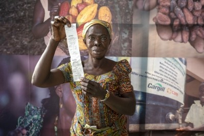 A female cocoa farmer with proof of her premium payment from Cargill. Pic: Cargill 
