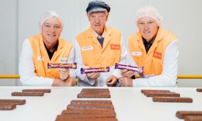 Robern Menz employees show off Violet Crumble bars from its production line. Pic:Julian Cebo 