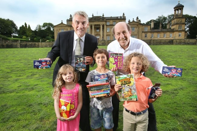 William Whitaker, managing director of Whitakers Chocolates, and Trevor Wilson from the Broughton Hall Children's Literature Festival with young book lovers
