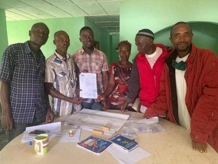 NGOCFU farmers sign and present their first export contract with Etico. Pic: Fairtrade