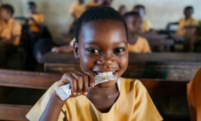 Mary Afrakomah, 7, at the Hemang Buoho D/A Primary School, Afigya Kwabre District, Ashanti Region, Ghana, holding a Vivi packet, a vitamin fortified groundnut-based snack that is provided to 50,000 school children in Ghana every day through Hershey’s Energize Learning program. Pic: The Hershey Company