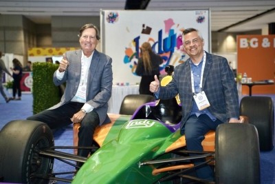 John Downs (eft), president and CEO of the NCA, sits with Leonard Hoops president & CEO of Visit Indy, on the Indy 500 car as the Expo heads to Indianapolis in 2024. Pic: NCA